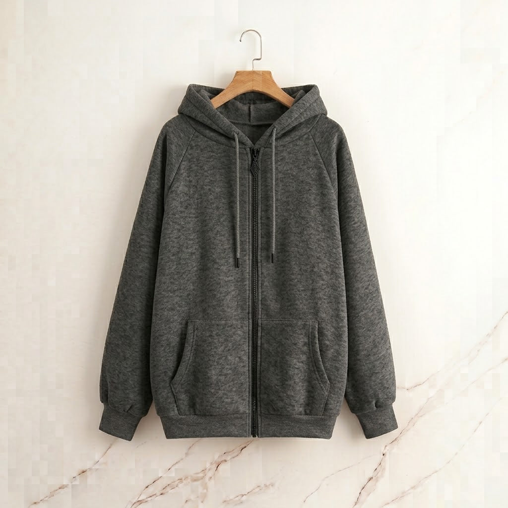 A dark gray zip-up hoodie with a drawstring hood and front pockets, hanging on a wooden hanger against a light beige marble-textured wall.