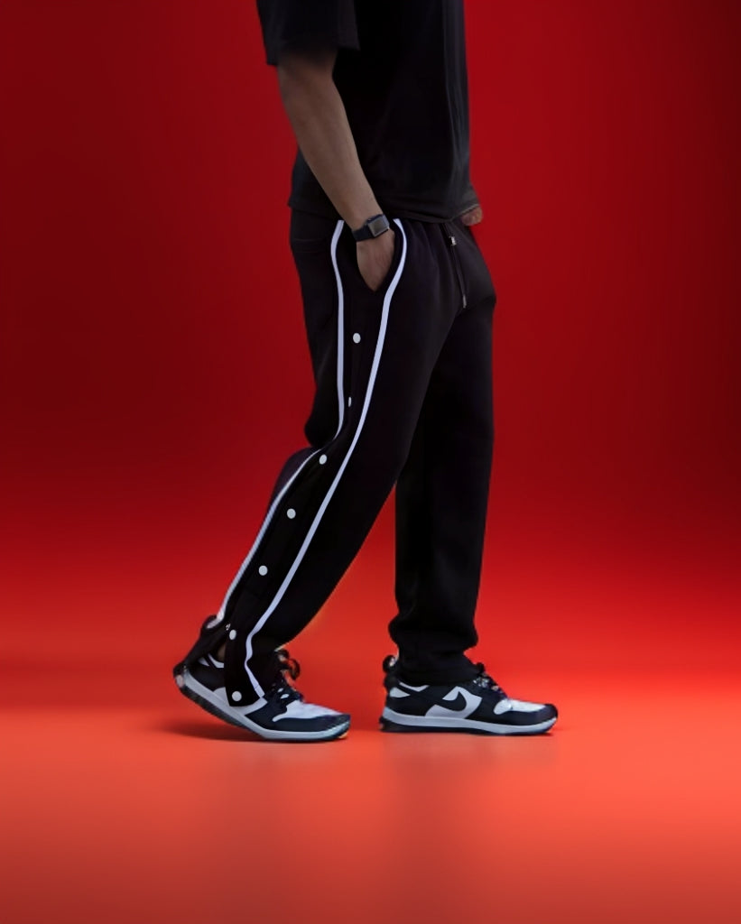 Black varsity pants with white side stripes and snap buttons - men's streetwear track pants