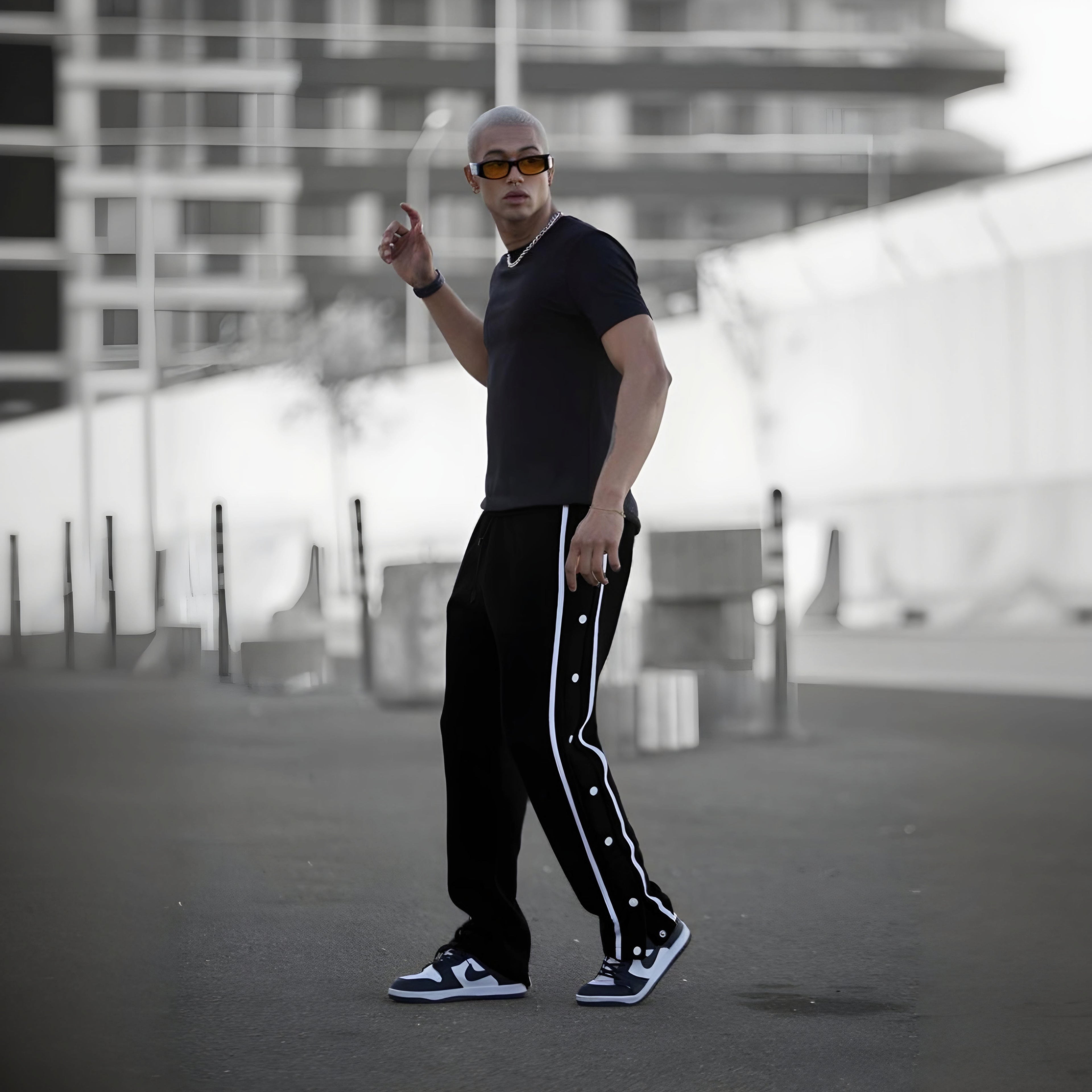 Black varsity pants with white side stripes and snap buttons - men's streetwear track pants