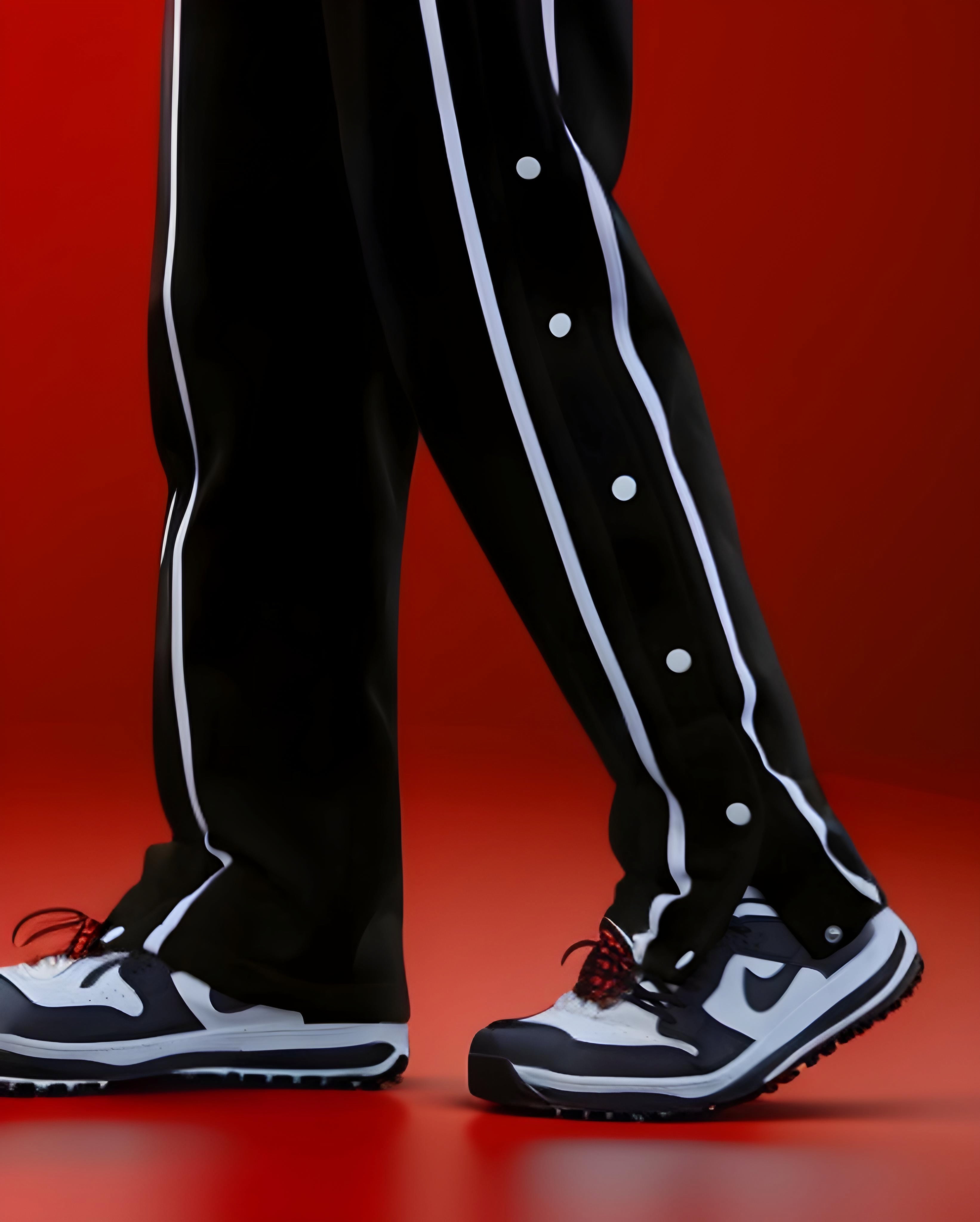 Black varsity pants with white side stripes and snap buttons - men's streetwear track pants